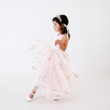 A girl in an embroidered flower girl lace dress with a crown